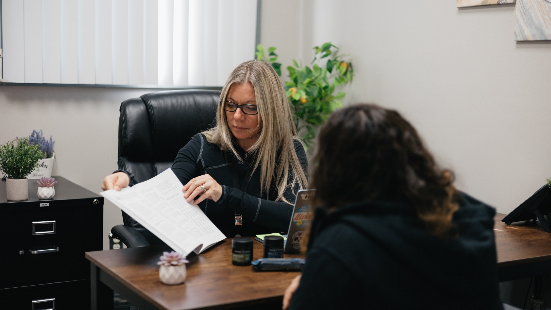 Medical cannabis consultant helping a patient learn about cannabinoid ratios at Central Ave Compassionate Care